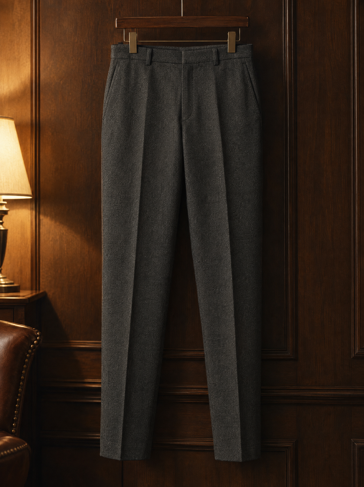 Charcoal tapered wool trousers on a wooden hanger
