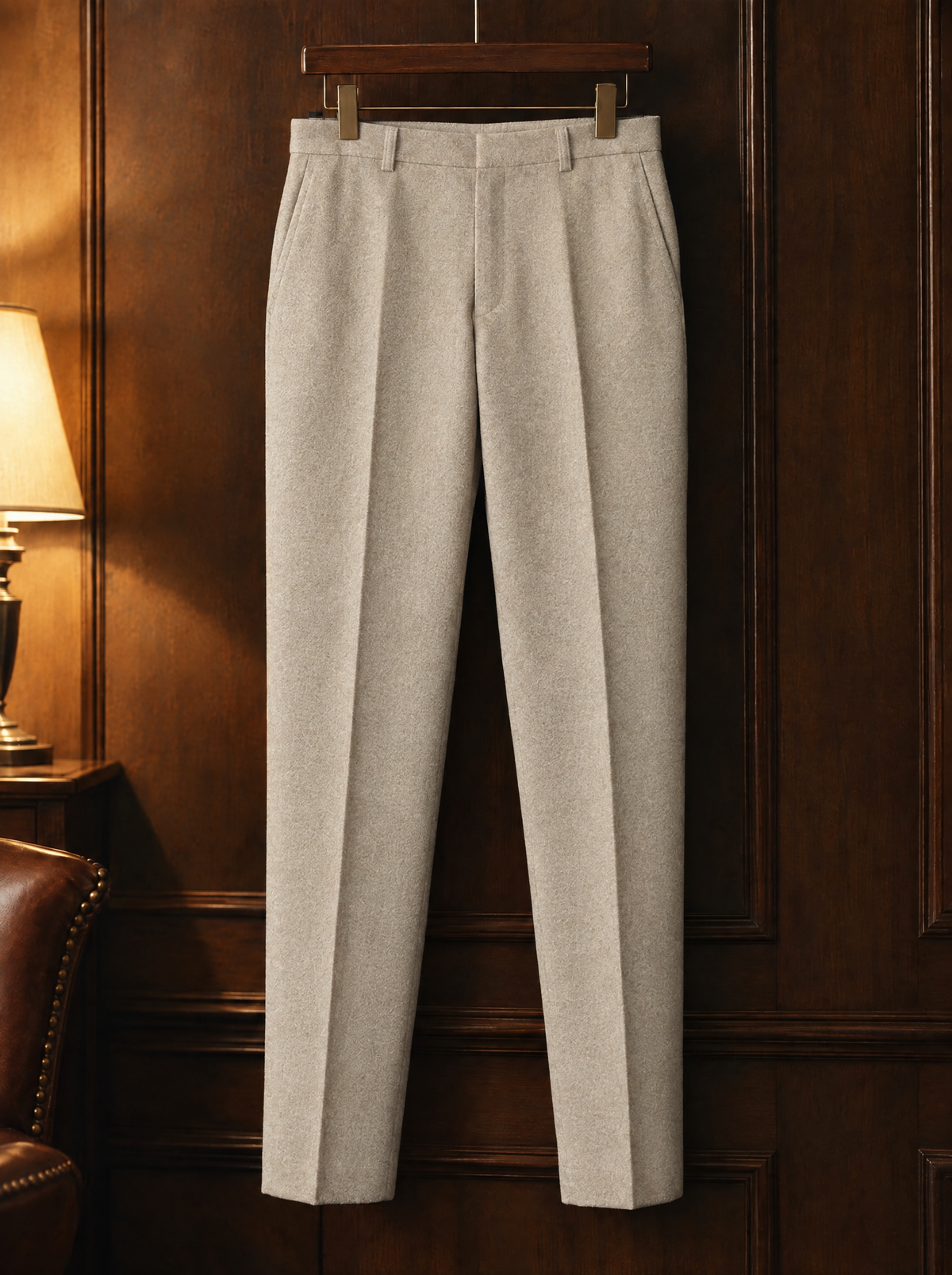 Stone tapered wool trousers on a wooden hanger