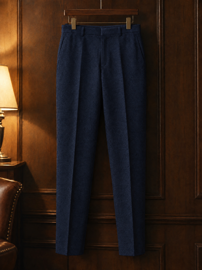 Navy tapered wool trousers on a wooden hanger